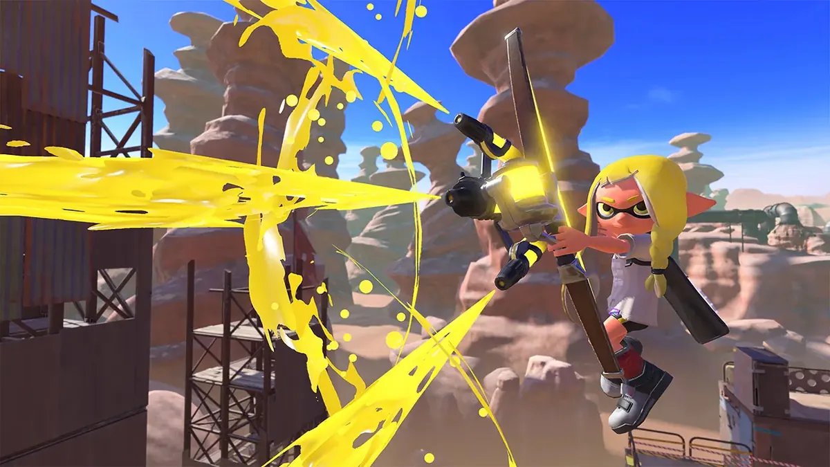 Captura oficial de Splatoon 3 com um Inkling disparando tinta amarela em uma arena
